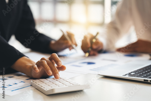 Fototapeta Naklejka Na Ścianę i Meble -  businesspeople cooperate work together discussing company financial statistics, colleagues employees collaborate brainstorm with finance document at meeting.