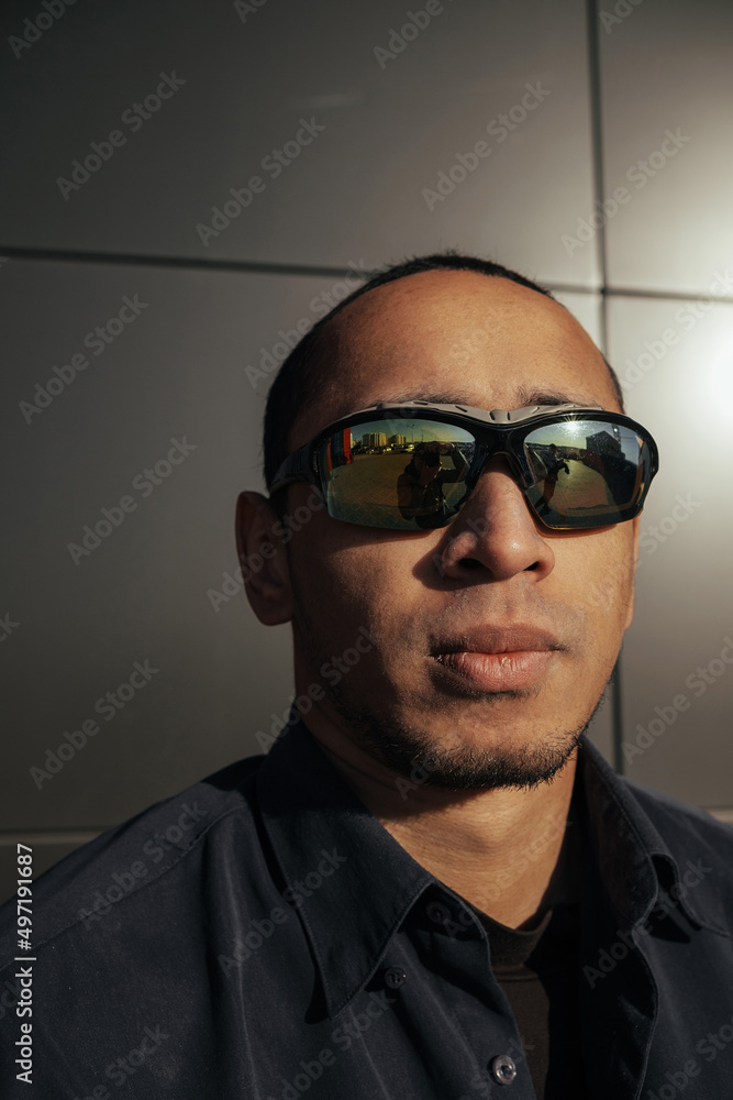 Obraz premium Portrait angry man screaming in studio. Closeup african american guy shouting on black background. Male model aggressive face expression. Serious man take off sunglasses.