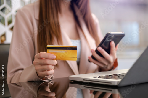 Business woman hands using smartphone and holding credit card as Online shopping .