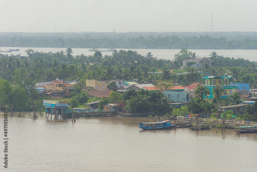 Fototapeta premium View of My Tho city, Tan Long island and marina, Rach Mieu bridge with transportation, energy power infrastructure in Mekong Delta, day and night.