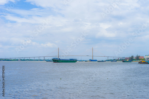 View of My Tho city, Tan Long island and marina, Rach Mieu bridge with transportation, energy power infrastructure in Mekong Delta, day and night.