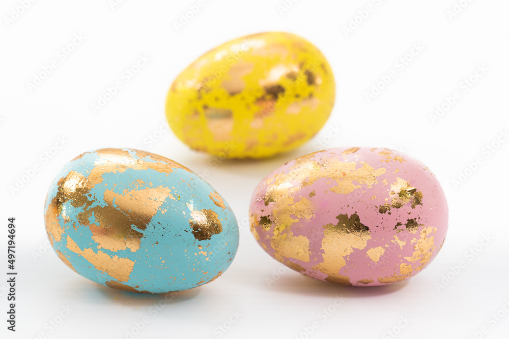 Three decorative Easter eggs against a white background. Easter eggs are traditionally given at Easter. 