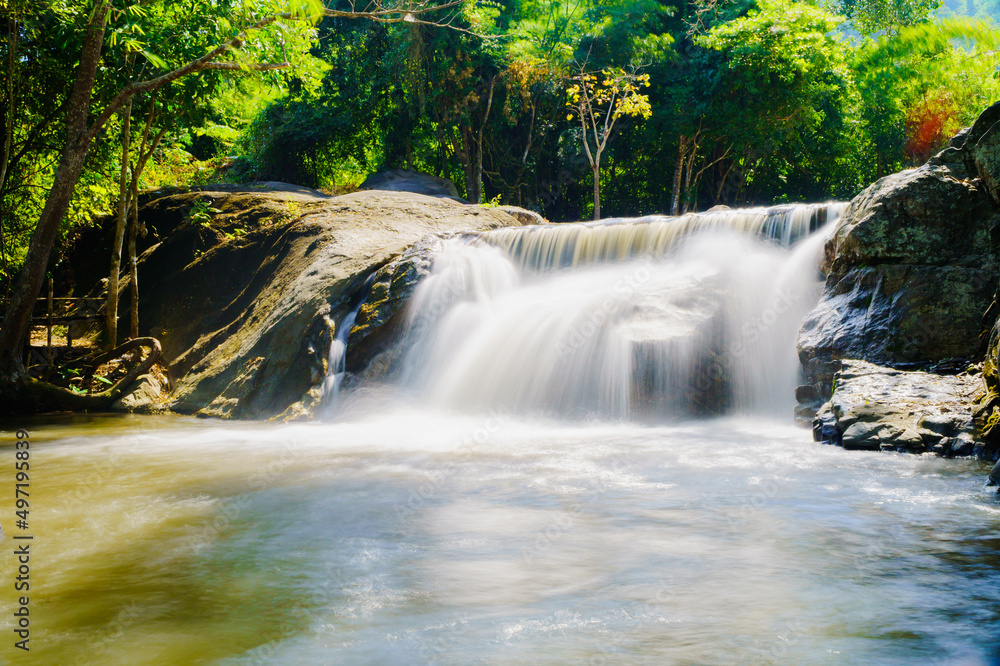 Water flowing along rocks in nature, waterfall