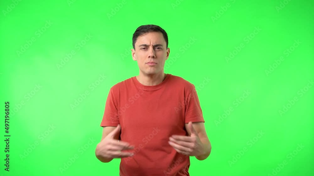 Man in red t-shirt advising calmness on chromakey Man in red t-shirt advising calmness on chromakey