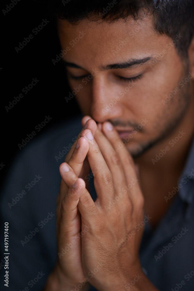 Faith will find the answer. Cropped shot of a young man holding his hands together in prayer. Faith will find the answer. Cropped shot of a young man holding his hands together in prayer.