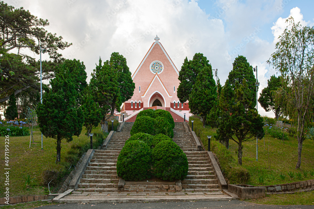 Mai Anh Domaine De Marie Church diocese on blue sky background, hidden behind pine tree on sunny day with front view, located in Da Lat, Lam Dong province, Vietnam Mai Anh Domaine De Marie Church diocese on blue sky background, hidden behind pine tree on sunny day with front view, located in Da Lat, Lam Dong province, Vietnam