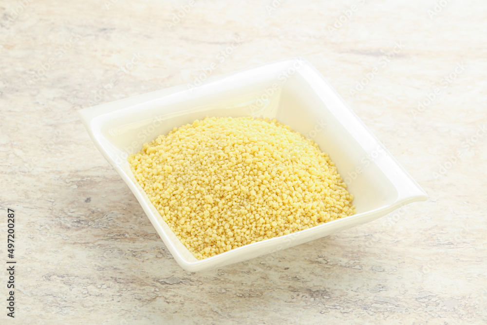 Raw couscous in the bowl Raw couscous in the bowl