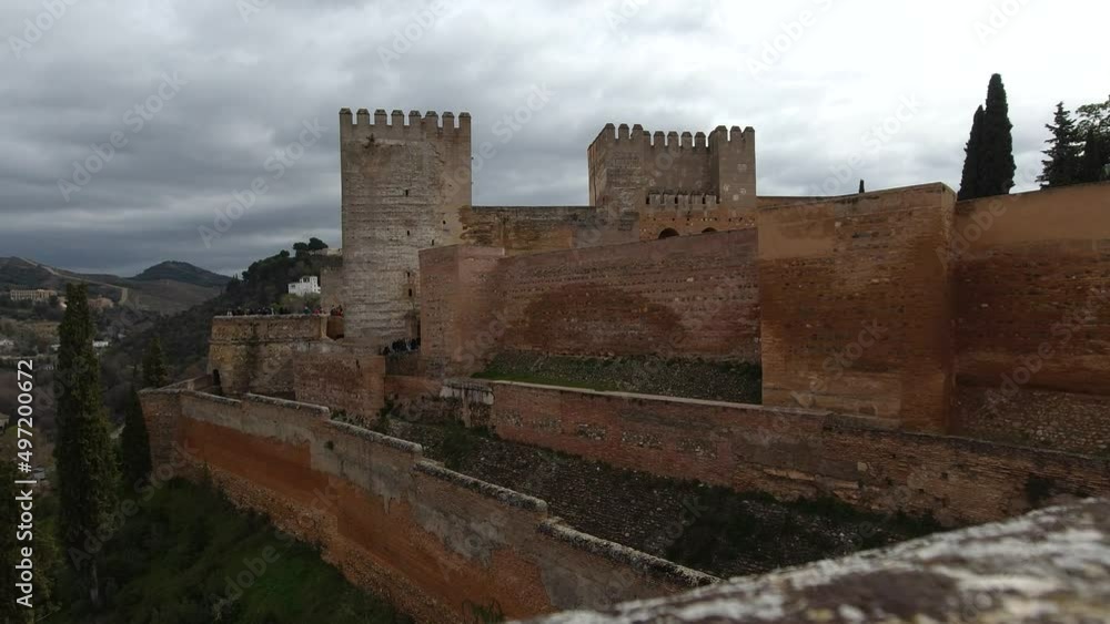 View of Alhambra fortress with grey cloudy sky View of Alhambra fortress with grey cloudy sky