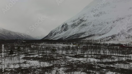 Flying over a snow covered forest in a desolate valley. Troms, Finnmark norhern Norway.
4k drone shot. photo