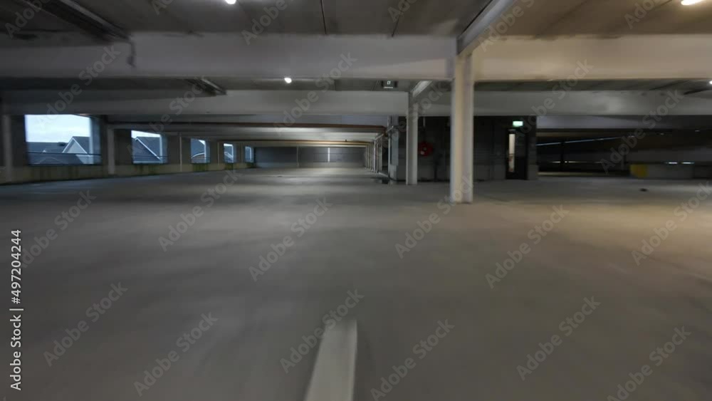Drone shot of a fast car driving in a car park Drone shot of a fast car driving in a car park
