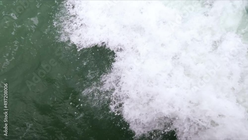 Wallpaper Mural Close-up of a blue foamy wave crashing on rocks in slow motion. Torontodigital.ca