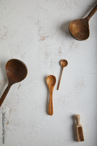 Set of old wooden spoons on white texturep background. Space for text photo