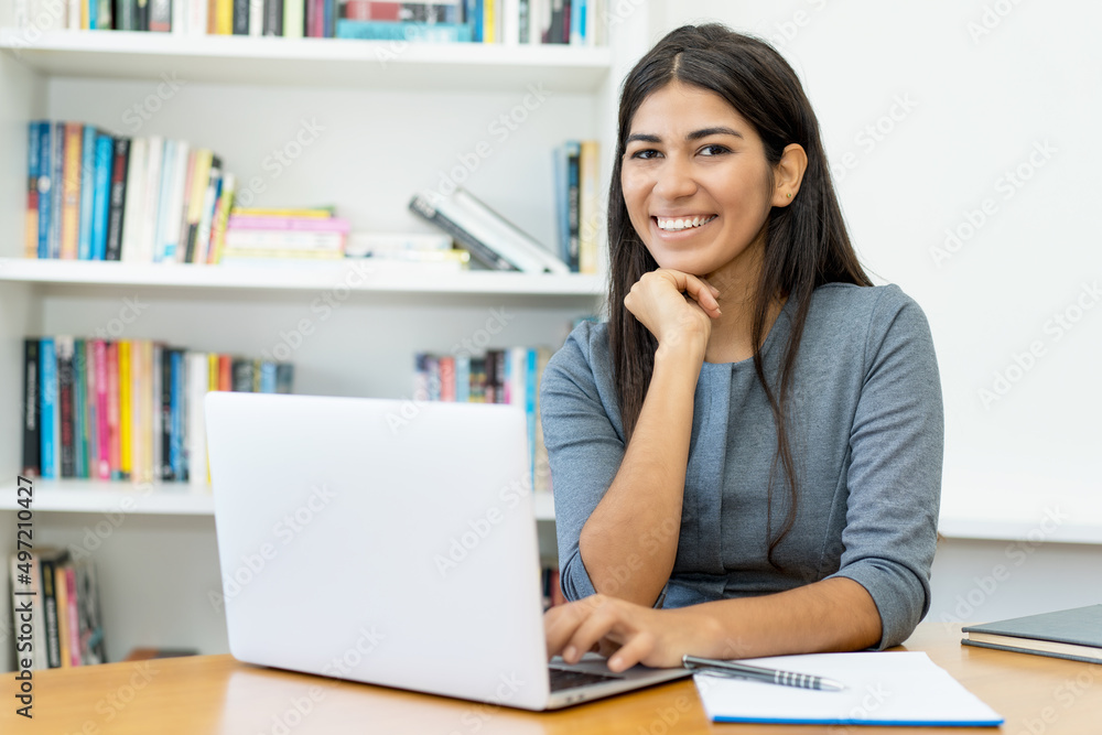 Pretty south american woman working at computer Pretty south american woman working at computer