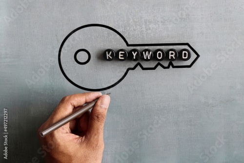 Text KEYWORD and drawing image of key. Search engine optimization, web search concept. photo