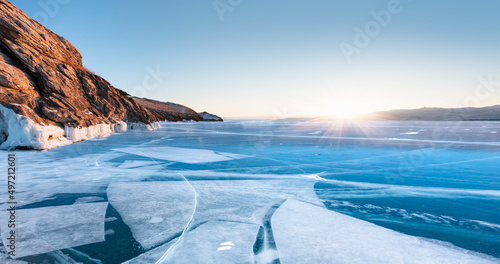 Ogoy island on winter Baikal lake with transparent cracked blue ice - Baikal, Siberia, Russia 