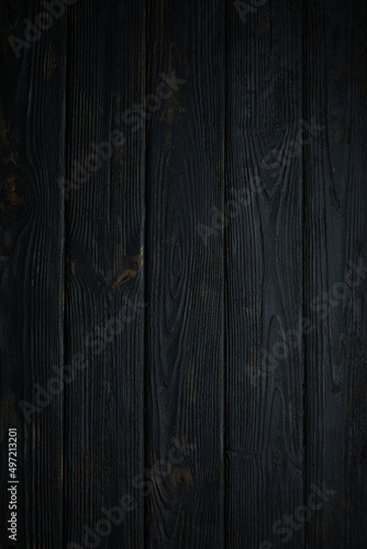 Black wooden background. Free space for your text. Top view.