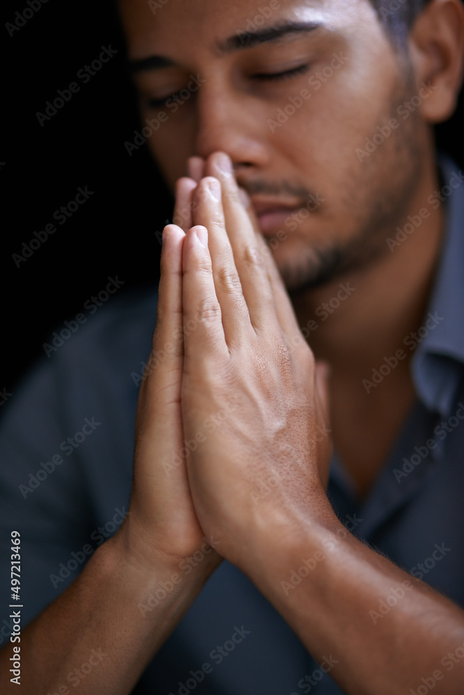Praying for guidance and strength. Cropped shot of a young man holding his hands together in prayer. Praying for guidance and strength. Cropped shot of a young man holding his hands together in prayer.