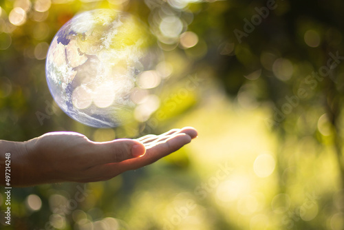 Together we can save the world and offer the better world for our children and Earth day concept, Butterfly and love heart shaped earth on hands, Elements of this image furnished by NASA