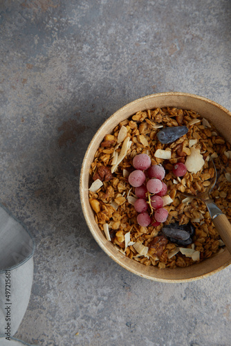 Healthy breakfast. Fresh granola, muesli with milk in a white bowl on grey background.