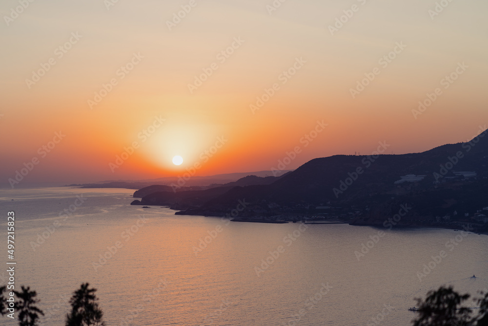 Beautiful abstract nature background with sea orange sunset on the coastline