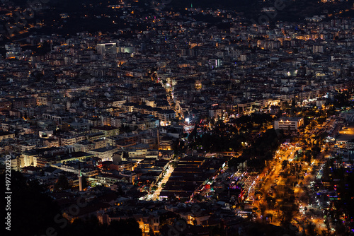 Alanya, Turkey - July 2021: Night view on The Alanya city, buildings and mountains with many city lights
