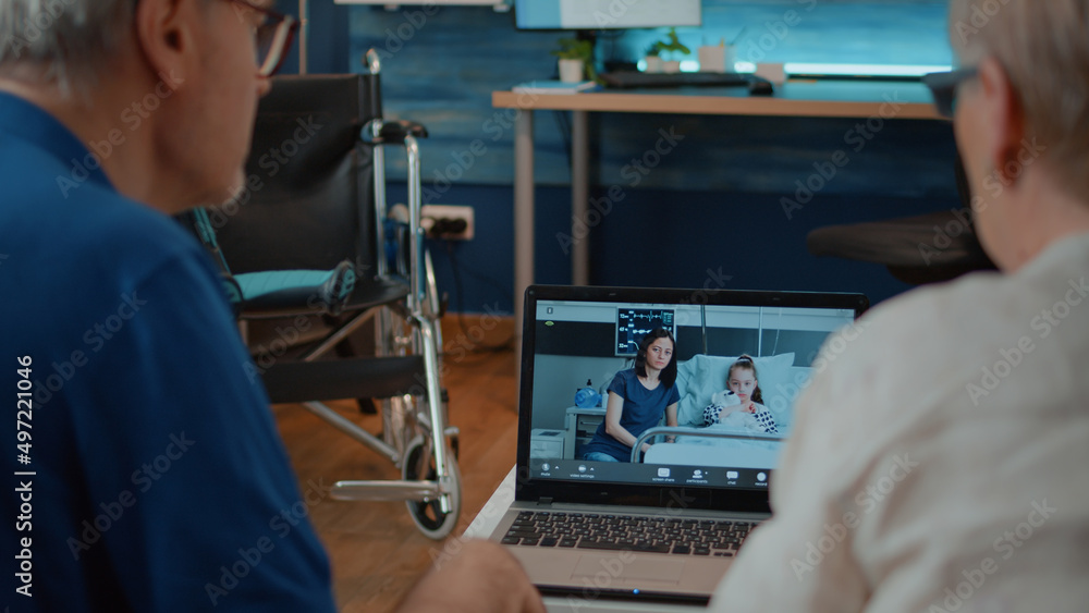 Obraz premium Grandparents talking to family in hospital on online conference, using laptop to talk about health care. Elder couple attending videoconference on internet connection. Remote communication