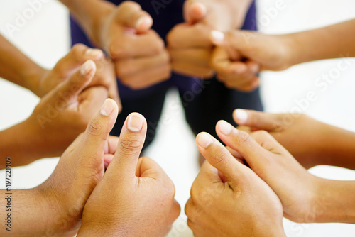 Teamwork concept: a group of diverse hands sharing a cross-processing of young people in nature.