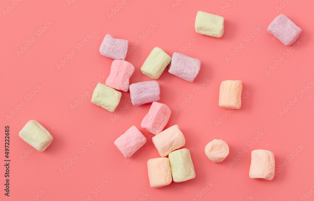 Multicolored candies on a pink background. Close-up Multicolored candies on a pink background. Close-up
