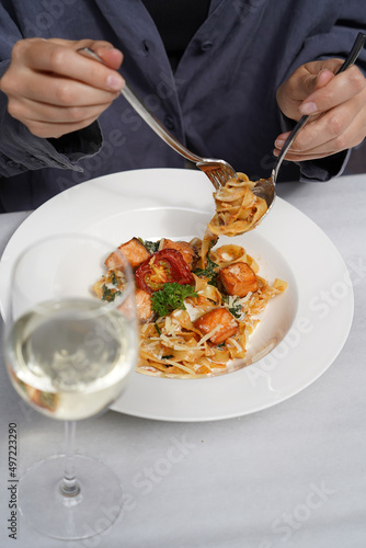 Tagliatelle pasta with salmon, baked tomato and parmesan cheese