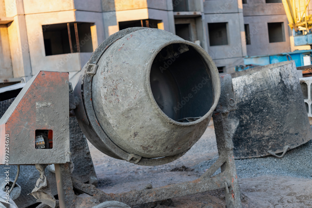 Industrial concrete mixer at a construction site. Preparation of concrete and mortar. Industrial concrete mixer at a construction site. Preparation of concrete and mortar.