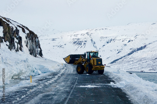 Cleaning the roads in winter landscape in Iceland of the Westfjorden