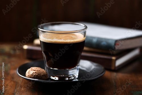 Coffee in glass cup on dark wooden background. Close up.