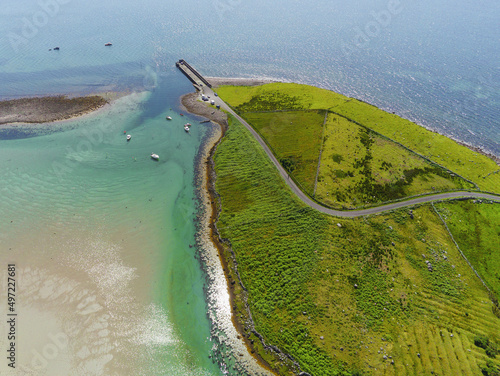 Aerial drone view on a Mulranny pier in county Mayo, Ireland Warm sunny day. Rich saturated blue color of water and sky. Travel and tourism. Irish nature landscape scene. photo