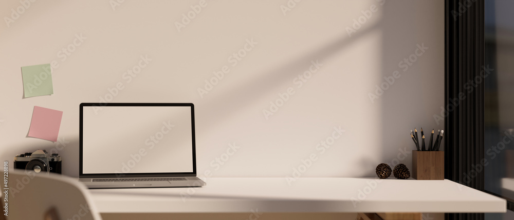 Minimal workspace with portable laptop white screen mockup over white wall.