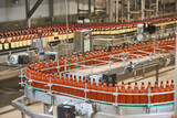 Plastic bottles for beer or carbonated beverage moving on conveyor
