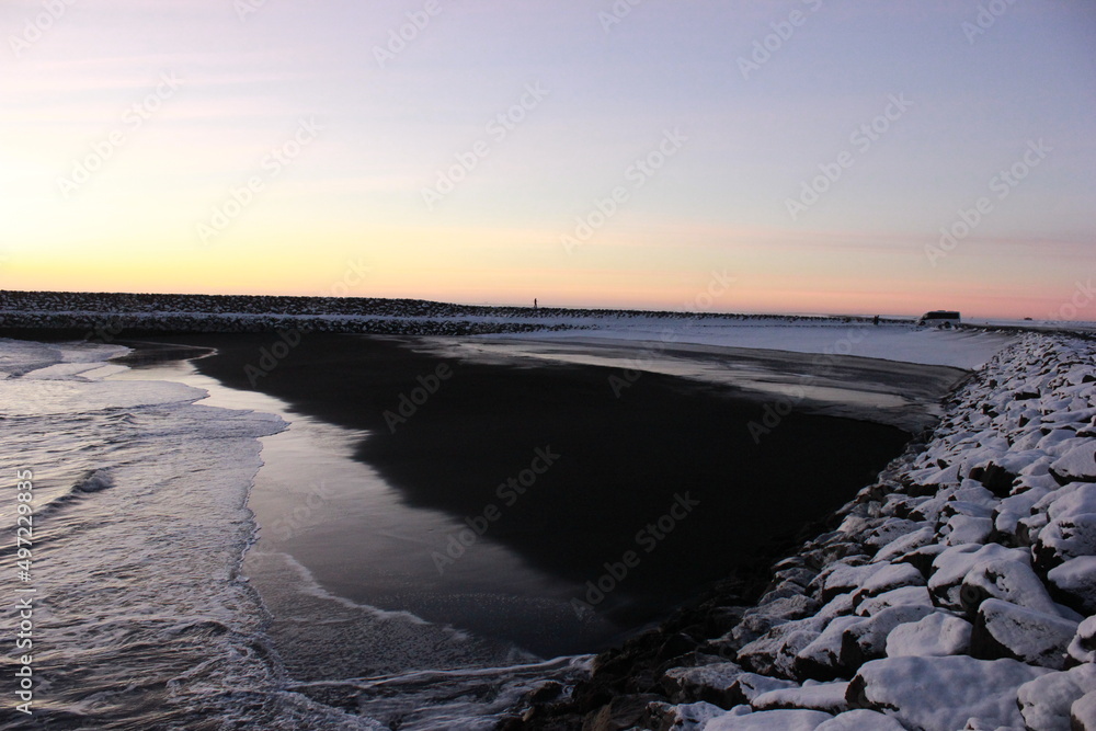 Ocean Shore in sunset surrounded by snow and ice
