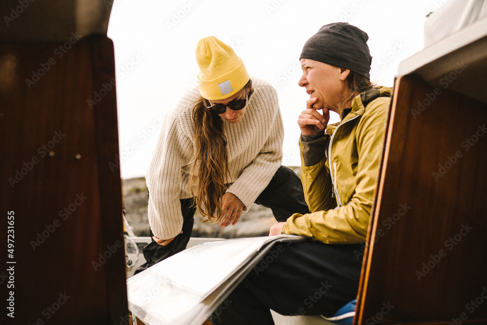 Women looking at map on boat Women looking at map on boat
