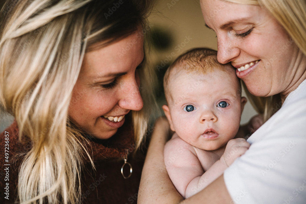 Smiling mothers holding newborn baby Smiling mothers holding newborn baby