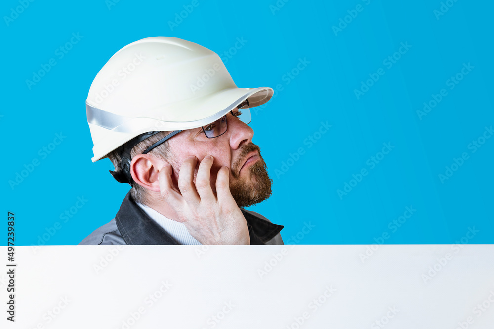Positive friendly bearded male builder in overalls and safety hardhat and goggles looking at the camera over isolated background. Positive friendly bearded male builder in overalls and safety hardhat and goggles looking at the camera over isolated background.