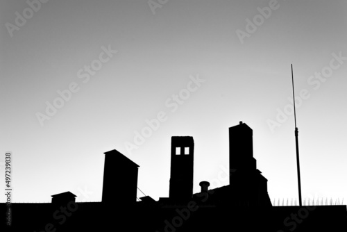 Low angle silhouette of buildings under cloudless clear sky