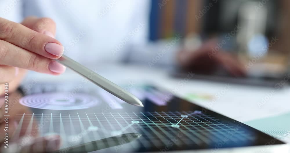 Analyst studies financial business charts on tablet Analyst studies financial business charts on tablet