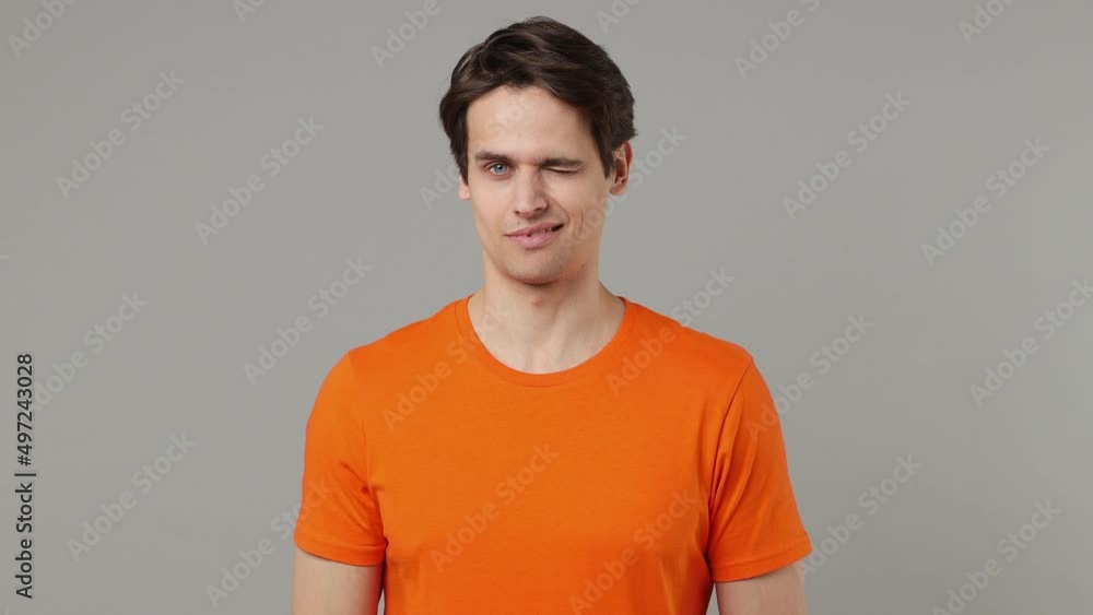 Secret serious charismatic vivid young brunet man 20s wears orange t-shirt look camera do shhh gesture close his mouth lock and throw away key isolated on plain grey wall background studio portrait Secret serious charismatic vivid young brunet man 20s wears orange t-shirt look camera do shhh gesture close his mouth lock and throw away key isolated on plain grey wall background studio portrait
