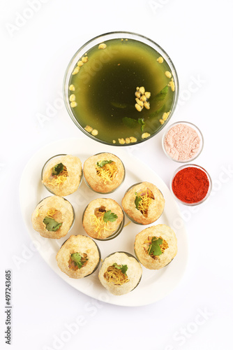 Panipuri or Golgappa is a popular street snack from India. It's a round, hollow puri filled with a mixture of flavoured water and other chat items photo