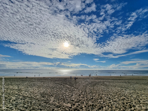 Breathtaking view from a beach against blue sky background with altocumulus clouds photo