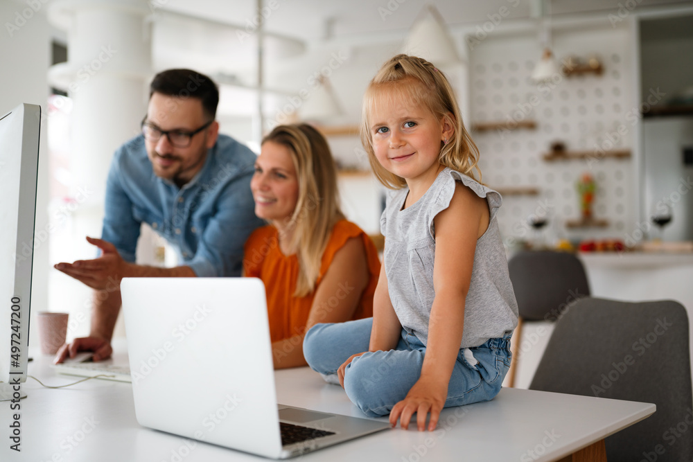 Working from home with child. Busy business parents working while kid playing on laptop. Working from home with child. Busy business parents working while kid playing on laptop.