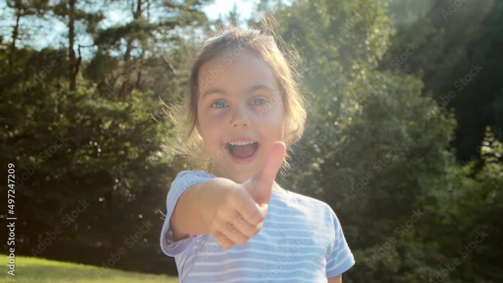 Cheerful little girl showing different hand gestures Cheerful little girl showing different hand gestures