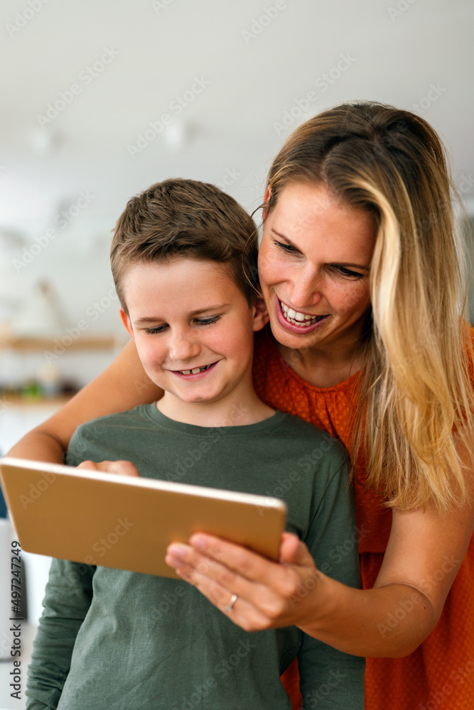 Mother and child using digital tablet for e-learning. Education home digital device kid concept. Mother and child using digital tablet for e-learning. Education home digital device kid concept.