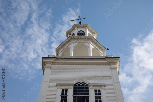 Low angle shot of the top of the Old First Congregational Church in Vermont against blue cloudy sky photo