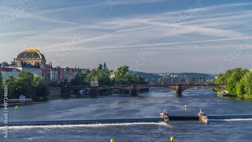 Vltava river timelapse in district Strelecky ostrov with the bridge of the Legions and National Theater building, Prague, Czech Republic photo