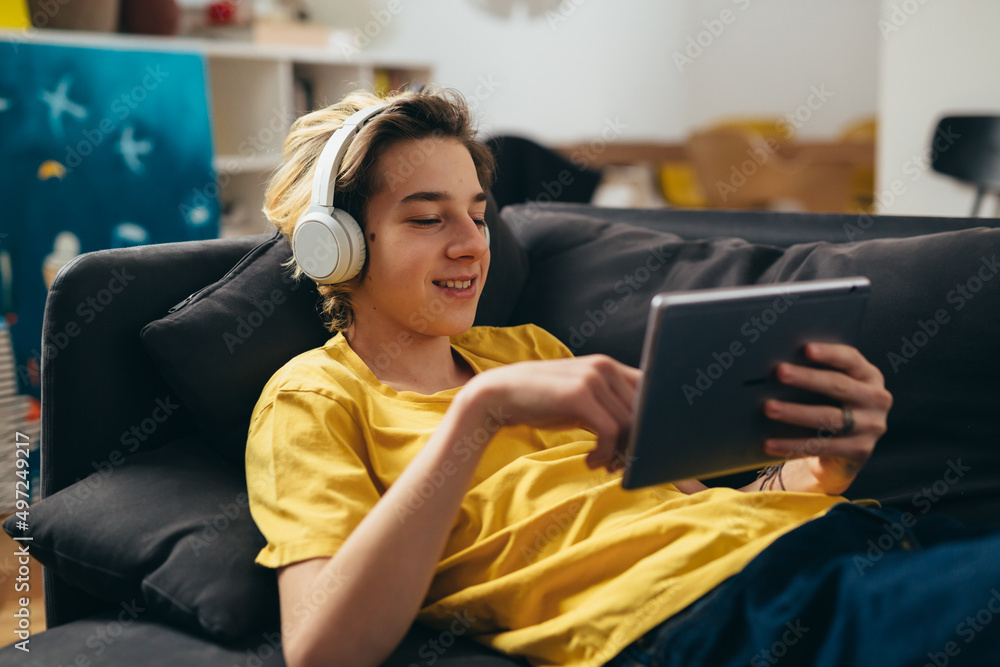teenager using digital tablet at home teenager using digital tablet at home